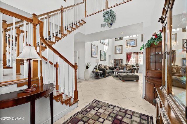 tiled foyer entrance featuring a towering ceiling