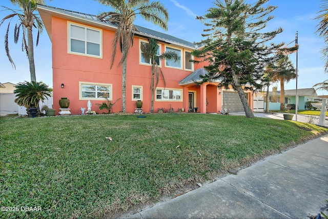 view of front of property featuring a garage and a front yard