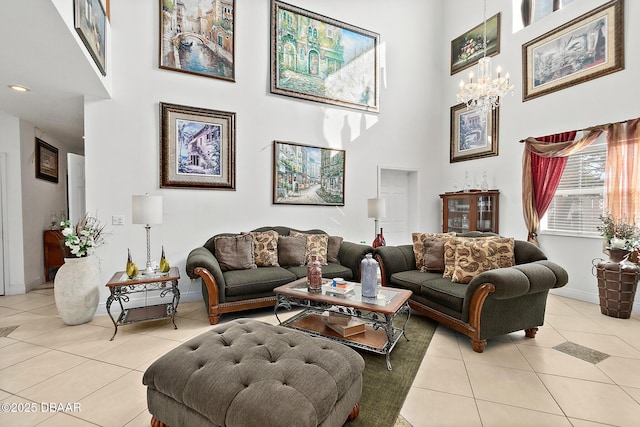 tiled living room featuring a towering ceiling and a chandelier