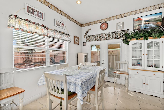 dining room featuring french doors and light tile patterned floors