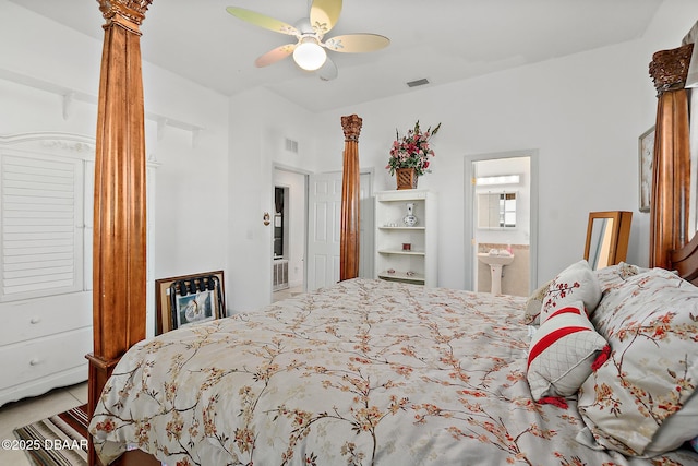 bedroom featuring ornate columns, ceiling fan, and ensuite bathroom