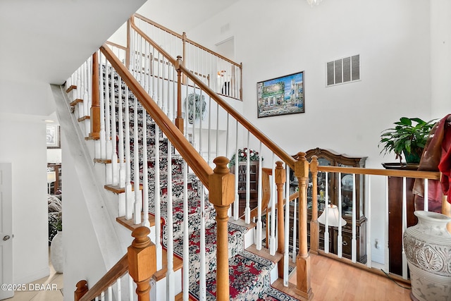 stairway with hardwood / wood-style floors