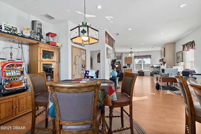 dining space with ceiling fan and light hardwood / wood-style floors