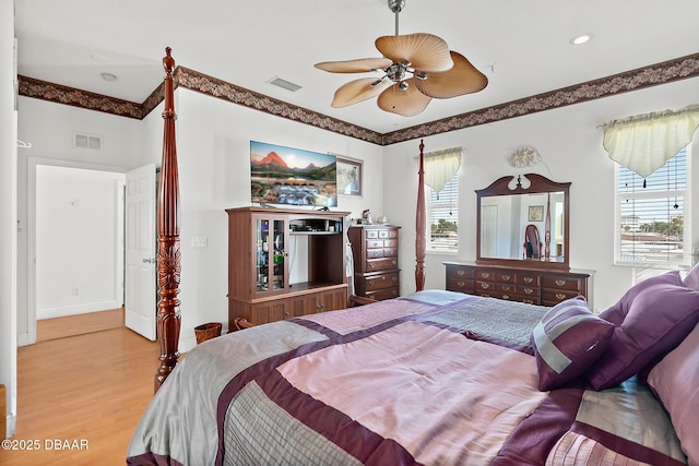 bedroom with ceiling fan and light hardwood / wood-style floors