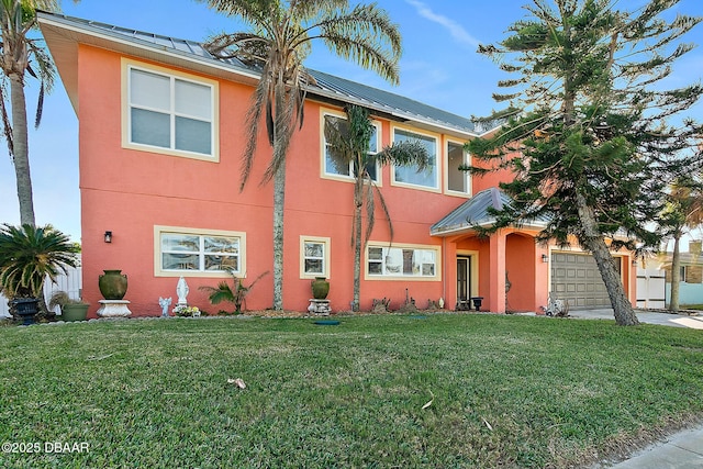 view of front of home with a garage and a front yard