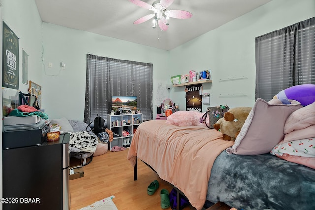 bedroom with wood-type flooring and ceiling fan