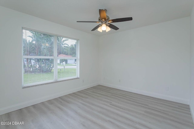 spare room with light hardwood / wood-style floors, a healthy amount of sunlight, and ceiling fan