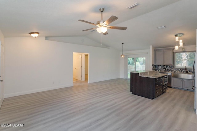 kitchen with light hardwood / wood-style floors, a center island, vaulted ceiling, gray cabinetry, and ceiling fan