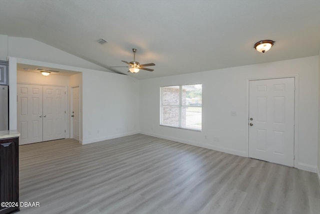 unfurnished living room featuring light hardwood / wood-style floors, lofted ceiling, and ceiling fan