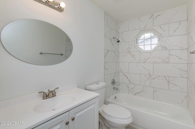 full bathroom featuring tiled shower / bath, toilet, and vanity