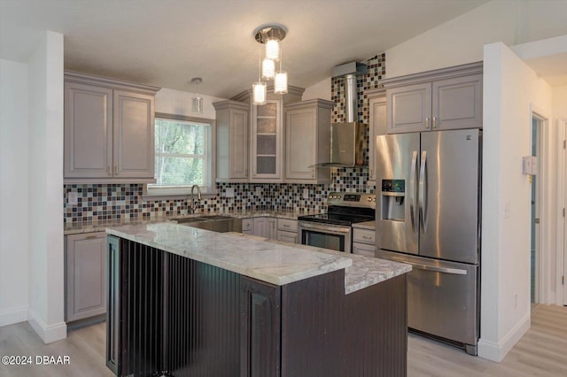 kitchen with light stone counters, stainless steel appliances, decorative backsplash, sink, and light hardwood / wood-style flooring