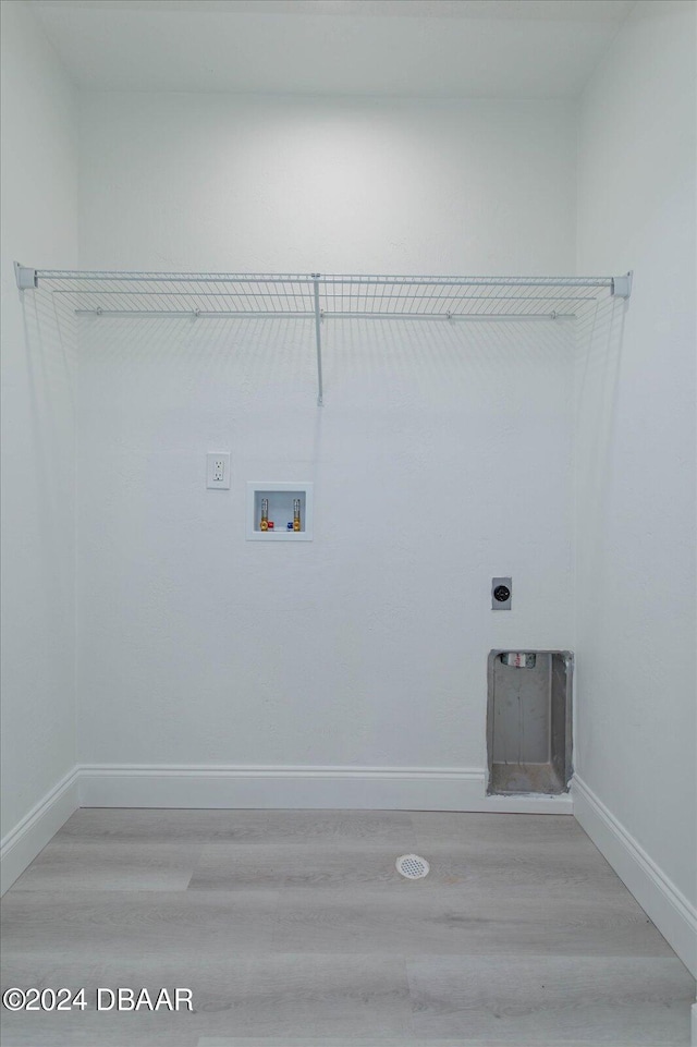 washroom featuring hardwood / wood-style floors, electric dryer hookup, and hookup for a washing machine