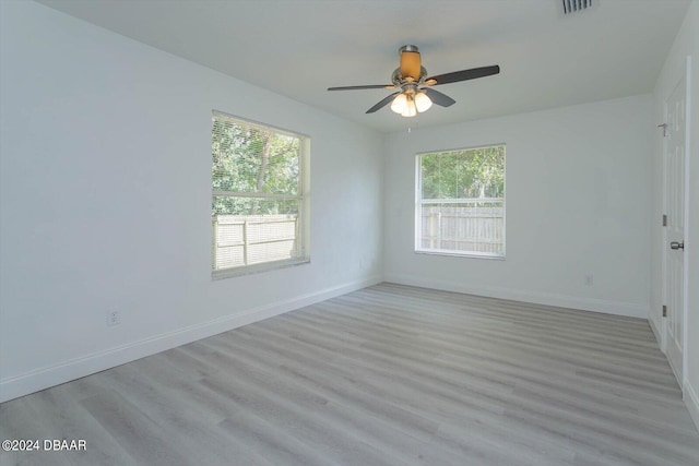 unfurnished room with ceiling fan and light hardwood / wood-style flooring