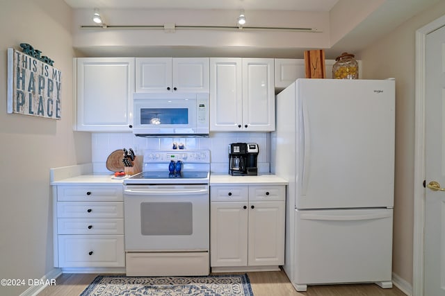 kitchen featuring light wood-type flooring, white appliances, white cabinetry, and backsplash