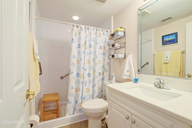 bathroom featuring a shower with curtain, a textured ceiling, wood-type flooring, vanity, and toilet