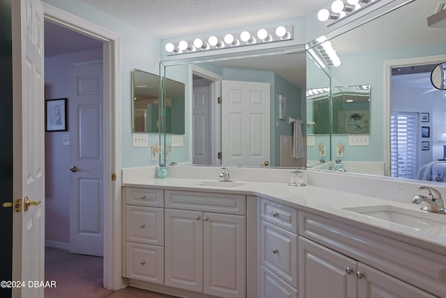 bathroom with vanity and a textured ceiling