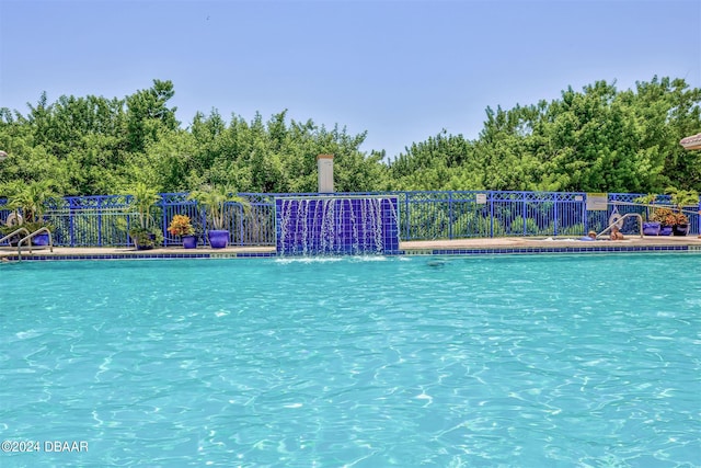 view of swimming pool featuring pool water feature