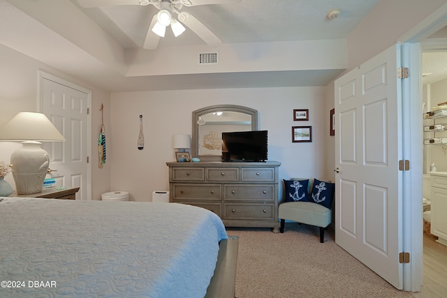 bedroom featuring light colored carpet and ceiling fan