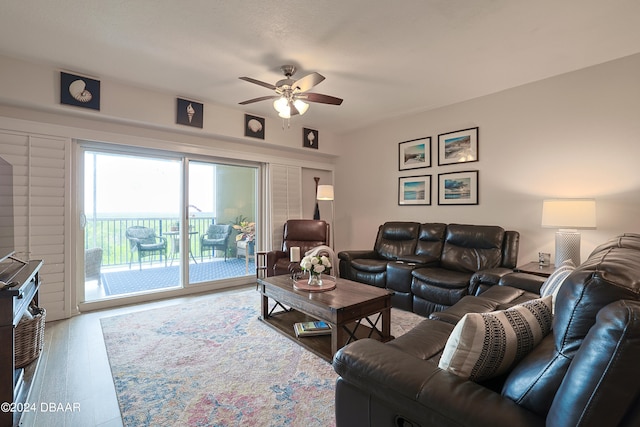 living room featuring wood-type flooring and ceiling fan