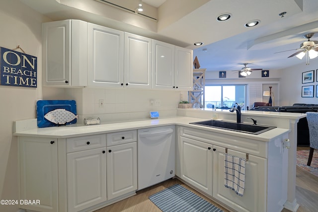 kitchen featuring kitchen peninsula, white cabinetry, sink, and dishwasher