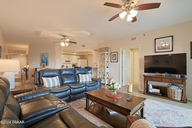 living room featuring light hardwood / wood-style flooring and ceiling fan