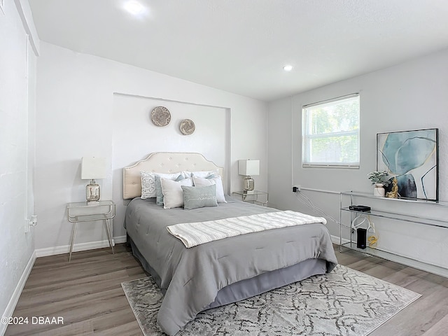 bedroom with wood-type flooring