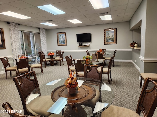 4670 Links Village Dr Unit D204, Ponce Inlet, FL 32127 - dining room featuring carpet flooring, a paneled ceiling, and baseboards