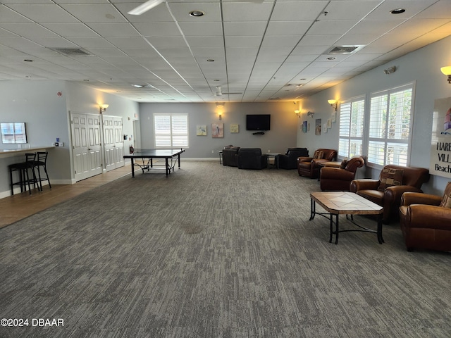 interior space featuring plenty of natural light and a paneled ceiling