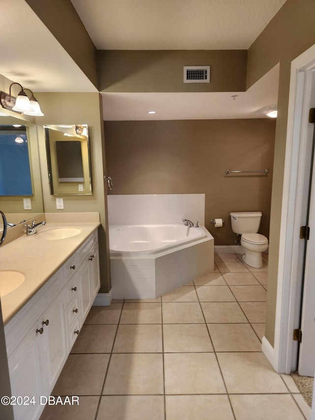 bathroom featuring a relaxing tiled tub, tile patterned flooring, toilet, and vanity