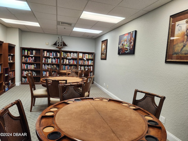 office with a paneled ceiling and carpet floors