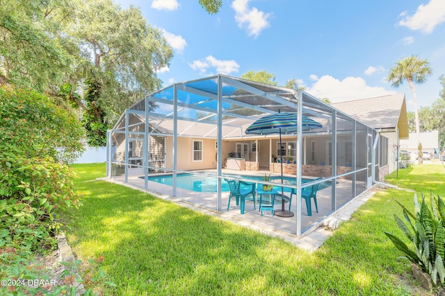 rear view of house with a lanai, a yard, and a patio