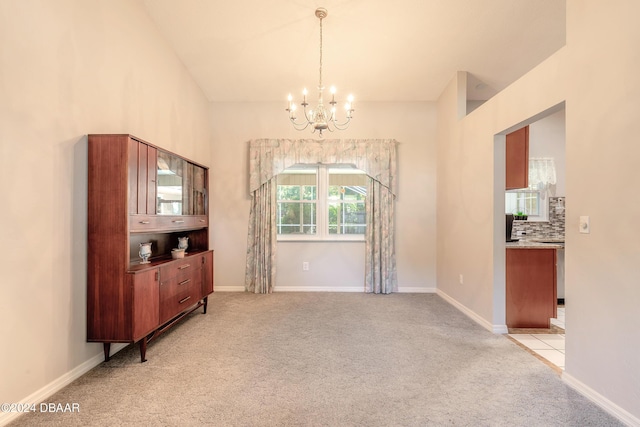 carpeted dining area with a notable chandelier