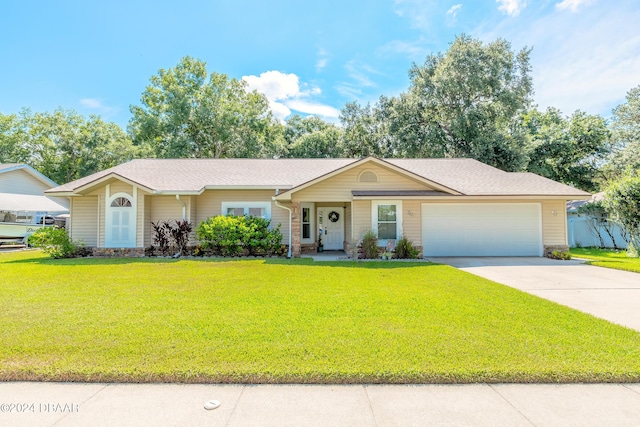 ranch-style home featuring a front lawn and a garage