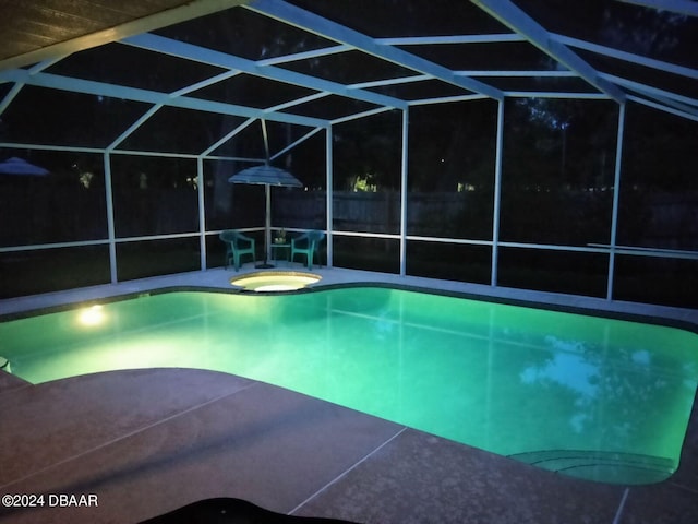 view of swimming pool featuring glass enclosure, a patio area, and an in ground hot tub