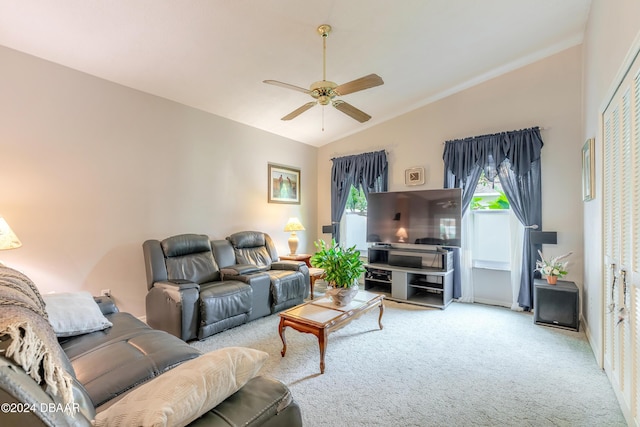 carpeted living room featuring ceiling fan and vaulted ceiling