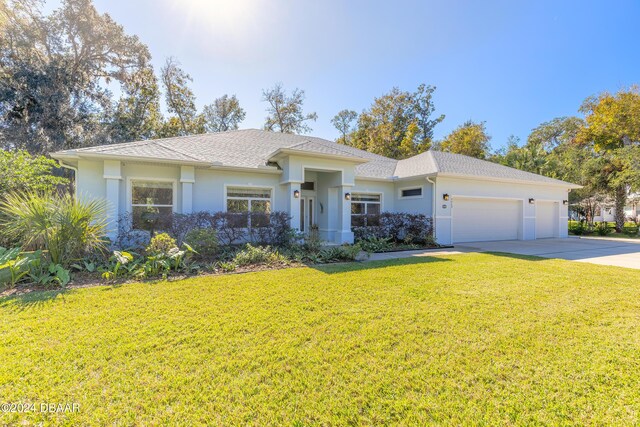 view of front facade featuring a garage and a front yard