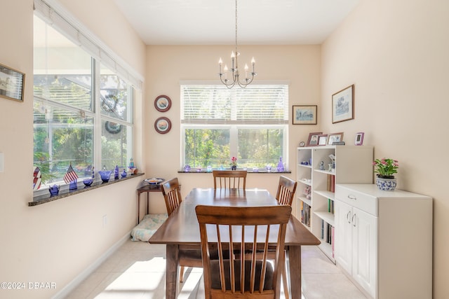 dining room with light tile patterned floors and a chandelier