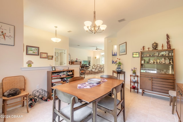 tiled dining space with ceiling fan with notable chandelier