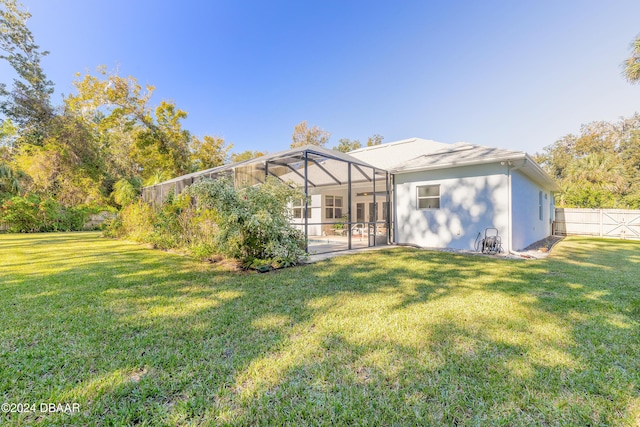 back of property with a patio, a lanai, and a lawn