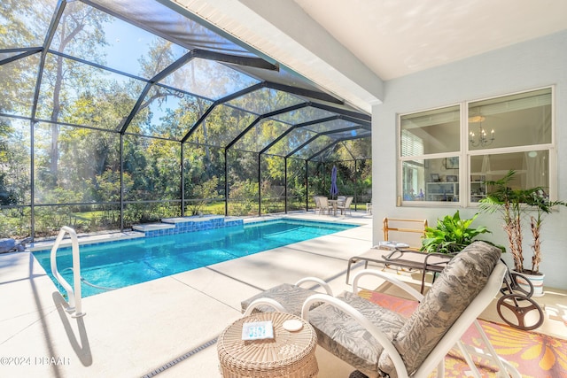 view of pool with glass enclosure and a patio area