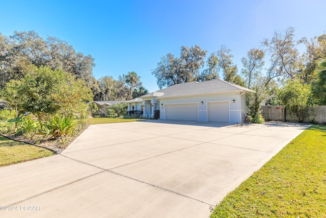 view of side of property featuring a garage and a yard