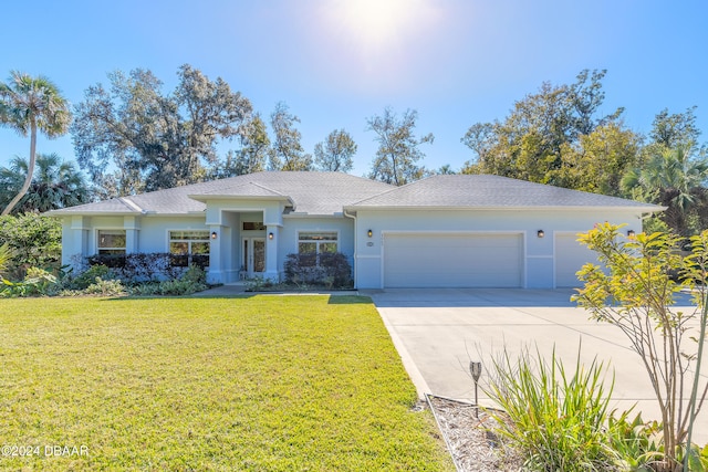 view of front of house with a front yard and a garage