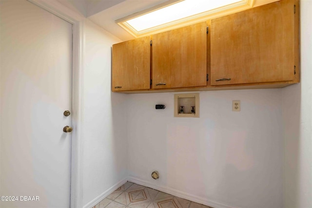 washroom featuring hookup for an electric dryer, washer hookup, and cabinets