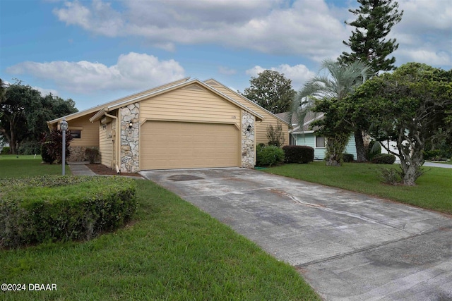 single story home featuring a garage and a front yard