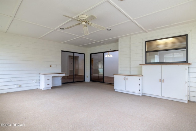 interior space featuring light carpet and ceiling fan