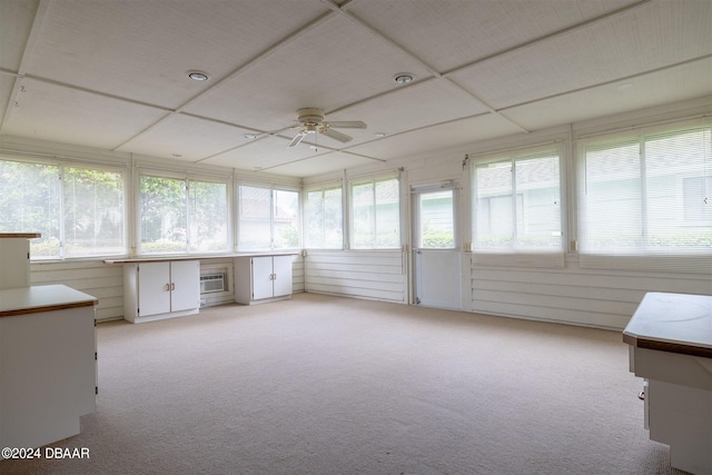 unfurnished sunroom featuring ceiling fan