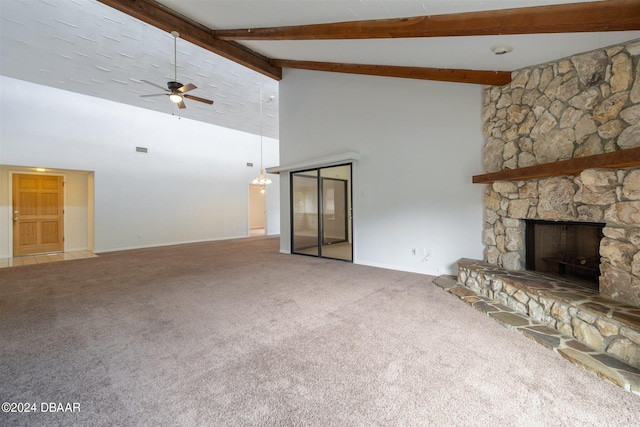 unfurnished living room featuring a fireplace, carpet flooring, high vaulted ceiling, beamed ceiling, and ceiling fan