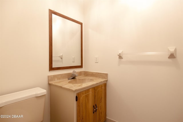 bathroom featuring toilet and vanity