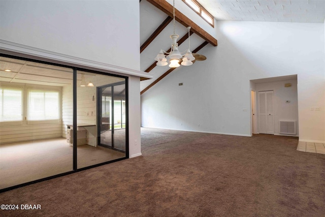 carpeted empty room with ceiling fan, beam ceiling, and high vaulted ceiling