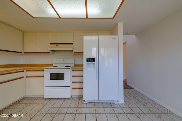 kitchen with white appliances and light tile patterned floors